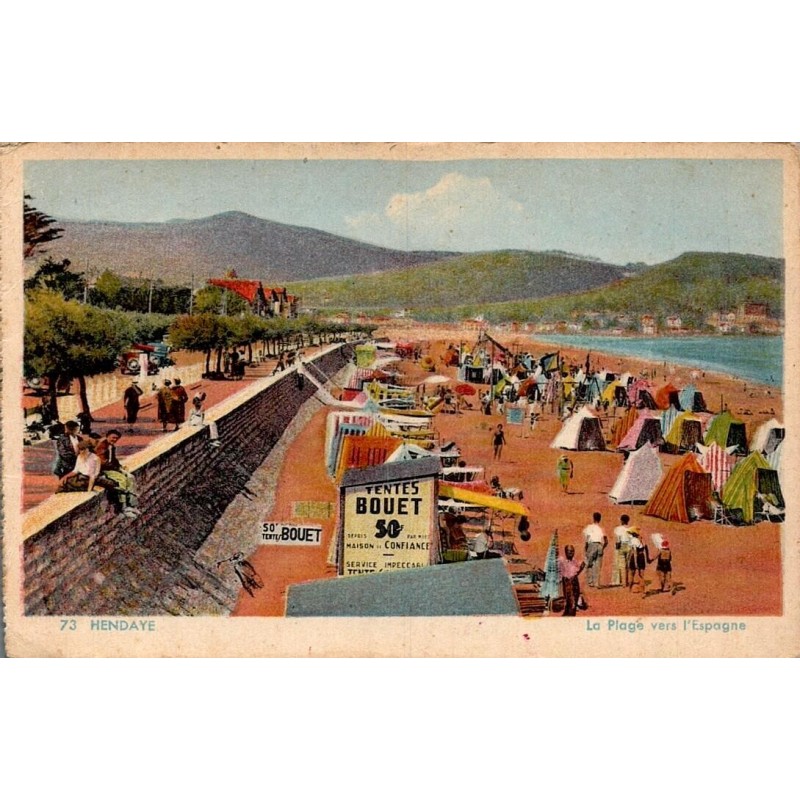 Carte postale ancienne d'Hendaye montrant la plage vers l'Espagne avec tentes, promeneurs et front de mer.
