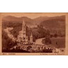 Carte postale ancienne de Lourdes montrant la basilique vue depuis le Château-Fort, oblitérée en 1951.