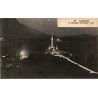 Carte postale ancienne de Lourdes montrant la basilique illuminée de nuit au sanctuaire