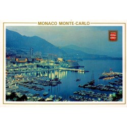 Carte Postale Moderne de Monaco montrant Monte-Carlo et le Port Hercule illuminés de nuit avec message manuscrit.
