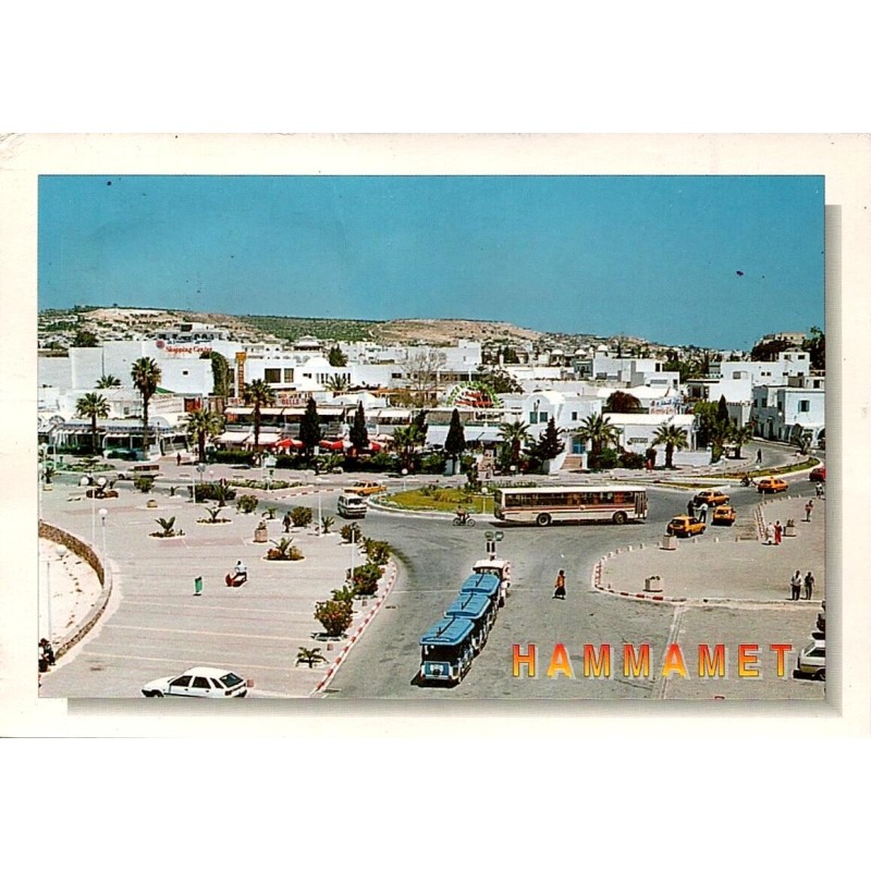 CPM Hammamet montrant le centre-ville, un petit train touristique, des autocars et des taxis