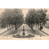 Carte postale ancienne de l'avenue de la Gare à Montluçon avec fontaine et promenade arborée.